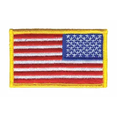 Sew-on embroidered emblem featuring a reverse U.S. flag design. Measures 3-3/8 inches by 2 inches. Gold plastic construction. Attaches to fabric via stitching. Suitable for uniforms, tactical gear, bags, and apparel.