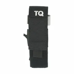 Black nylon field-use arterial tourniquet holder with overall length of 6 1/2 in and width of 2 in. Designed for secure retention and quick access in emergency response and tactical environments.