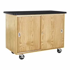 This wood mobile cabinet includes an integrated work surface for use as a portable workstation or storage unit. With a 36-inch overall height, 24-inch depth, and 4-foot width, it is suited for mobile storage and workspace applications in industrial, office, and light-commercial environments.
