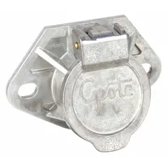 Trailer receptacle with a diameter of 3 15/16 inches. Features solid brass pins for corrosion resistance and consistent electrical conductivity. Used to connect electrical systems between a towing vehicle and trailer for lighting and signal functions.