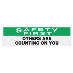 Indoor/outdoor banner printed on one side, made of poly sheeting. Nominal sign size 28 in x 96 in. No wind slits. Suitable for displaying safety messages in industrial facilities such as workshops, warehouses, and plant floors.