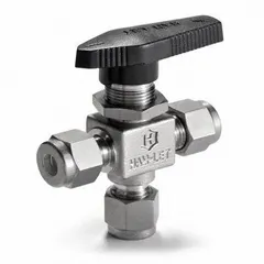 This manual three-way ball valve from HAM-LET features a 1/4 in connection and a one-piece stainless steel body. It is used to divert or mix flow in industrial piping systems, suitable for applications requiring corrosion resistance such as chemical processing, oil and gas, and instrumentation.