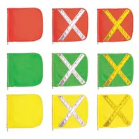 This replacement whip flag features a green body with a yellow reflective X for enhanced visibility. Measuring 16 inches by 16 inches, it is used to mark slow-moving vehicles, construction zones, and industrial equipment