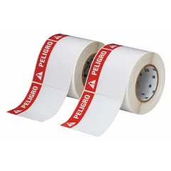 White polyester label roll with PELIGRO header, measuring 4 in x 4 in. Features rubber adhesive and is halogen-free. Contains 500 labels per roll. Compatible with Brady IP Series printers. Used for industrial hazard identification.