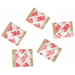 Transparent, acrylic double-sided film tape square with polyester film backing. Each pre-cut piece measures 1 1/2 in by 1 1/2 in and is 8.3 mil thick. Used for mounting, splicing, and bonding in industrial assembly and graphics applications.