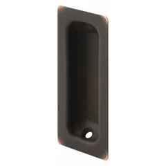 This oblong recessed pull handle is made of brass with an aged bronze finish. It has unthreaded mounting holes and an overall length of 3-1/4 inches. Suitable for use on cabinet trays, drawers, and similar applications in furniture or millwork.