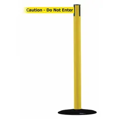 This retractable belt post barrier from TENSABARRIER features a yellow cast iron base and metal alloy post with a black belt printed 'Caution Do Not Enter'. The belt extends to 13 ft. Used for crowd control and area delineation in industrial environments such as warehouses and factories.