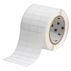 Thermal transfer precut label roll with rubber, aggressive adhesive for permanent bonding. Each label measures 1/2 in x 1 in. Compatible with THT-series printers. Used for industrial identification and labeling on surfaces such as plastics, metals, and textured materials.