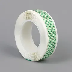 Permanent bonding tape on polyurethane foam with open acrylic adhesive. Square shape, 1 in by 1 in, 62.5 mil thickness, tan color. Used for mounting, sealing, and bonding on irregular surfaces in industrial assembly and maintenance.