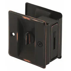 This PRIME-LINE pocket door pull handle features a tray/lever style made from brass with an aged bronze finish in black. It has unthreaded holes for mounting and is suitable for use on cabinet doors, drawers, and sliding panels in residential or light commercial settings.