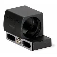 Plastic fixing clamp designed to mount 12 mm diameter inductive proximity sensors. Includes a mounting bracket with no hole. Used to secure sensors in position for consistent detection in industrial automation setups such as machinery and conveyors.