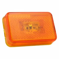 This LED clearance light features a rectangular amber lens with a grommet mount and PL-10 connector. It is used on trucks, trailers, and heavy equipment to mark vehicle width and height for visibility and regulatory compliance