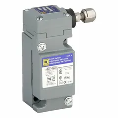 Metallic body limit switch with plunger actuator and screw clamp terminals. Features two mounting holes for side-mount installation. Used in industrial automation to detect position or presence of moving parts via mechanical actuation.