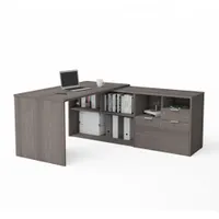 Laminate particle board L-shaped desk in Bark Grey finish. Overall width 71 1/8 in, overall depth 59 1/4 in. Designed for corner placement in office or home office settings, providing a spacious work surface for computer equipment, paperwork, and other office tasks