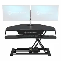 Electronic standing desk converter with a black wood desktop measuring 36 inches wide by 31 inches deep. Rated to BIFMA standards. Designed to convert a seated workstation into a sit-stand setup for improved ergonomics