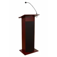 Stationary sound lectern with laminate construction in mahogany finish. Includes a battery, a handheld microphone, and a document rail. Suitable for public speaking, presentations, and events requiring amplified audio