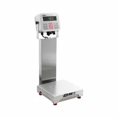 This B-TEK food scale features a 12-inch square weighing surface, 26-inch overall height, and an LCD display. It offers readability of 0.01 kg/10 g/0.02 lb/0.32 oz and is rated IP69K for resistance to high-pressure washdowns. An RS-232 port allows data transfer to external devices. Suitable for industrial weighing in food processing and sanitation-sensitive environments.