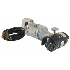 This palm-grip handheld corded scarifier operates on 115V AC and features a 5 in cleaning area. It includes a dust shroud for dust control. Typical applications include surface preparation and cleaning tasks such as removing coatings, rust, and debris from concrete, metal, and wood, particularly in confined or overhead work areas.