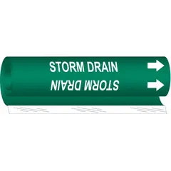Green wrap-around pipe marker with white legend text reading 'Storm Drain' and directional arrows. Fits pipe outer diameters from 1-1/2 to 2-3/8 inches. Used to identify storm drain piping in industrial and municipal systems.