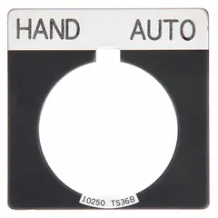 Square push-button legend plate with 30 mm panel mounting. Overall dimensions 1 3/4 in height and width. Black metallic aluminum construction with white 'Hand-Auto' legend in English and notch design. Used to label control stations for manual or automatic operation modes in industrial machinery.