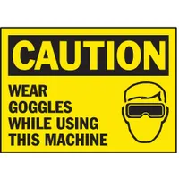 Adhesive-mounted polyester caution signs, 3 1/2 in x 5 in nominal size, 0.01 in thick. Sold in packs of 5. Suitable for placement on machinery or nearby surfaces to remind personnel to wear eye protection in work areas where goggles are required