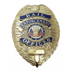 This oval metal badge features a gold finish and measures 2 1/4 inches by 3 1/8 inches. It is equipped with a pin and safety catch for attachment to clothing or uniforms. Typical applications include use as an identification badge for security personnel or law enforcement officers.
