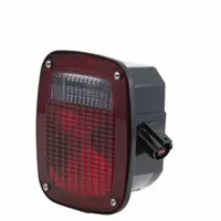 Incandescent combination light providing stop, turn, and tail functions. Features a clear/red square lens with red illumination. Designed for permanent stud-mount installation. Complies with FMVSS 108 standards for vehicle lighting