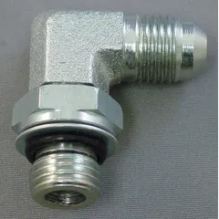 This rigid 90° elbow adapter connects hydraulic hoses or components with female NPTF threads on both ends. It provides a leak-resistant fluid connection in industrial hydraulic systems, such as those found in machining, material handling, and power transmission equipment.