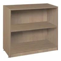 Wood stationary bookcase with Noble Oak laminate finish. Overall dimensions: 30 in height, 32 in width, 14 in depth. Suitable for storing books, binders, and decorative items in office or facility settings
