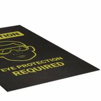 This safety entrance mat is made of polypropylene with an adhesive backing, measuring 3 ft x 5 ft and 1/8 in thick. It is designed for floor placement at entry points to indicate that eye protection is required, helping reinforce workplace safety protocols in areas where eye hazards exist