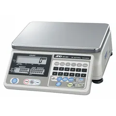 The HC-6KI is a compact bench scale from the HC-I Series with an 8 1/4 in x 11 3/4 in stainless steel platform. It offers readability of 0.002 lb/0.001 kg and includes an integrated RS-232C interface for data communication. This scale is suitable for industrial weighing tasks such as parts counting, checkweighing, and laboratory measurements.