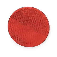 Round red stick-on reflector with acrylic lens, measuring 3 5/16 in overall length and width. Meets SAE A standards for vehicle marking. Used on trailers, trucks, and heavy machinery to enhance visibility in low-light conditions.