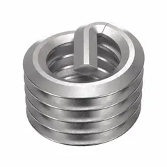 This HELI-COIL screw-locking tanged helical insert is made from 18-8 stainless steel with a dry film lubricant finish. It has a right-hand M6-1.00 coarse thread and a tensile strength of 200,000 to 250,000 psi. The insert requires a 6.25 mm drill bit and an M6-1.00 STI tap. It is used to repair or reinforce threads in metal components, providing wear-resistant threads in applications such as automotive, aerospace, and industrial machinery.