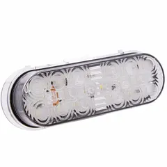Clear oval LED backup/reverse light with permanent grommet mount and DryFit connector. Measures 2 in height by 6 3/8 in width. DOT compliant. Suitable for use on vehicles, trailers, and equipment requiring reverse illumination.