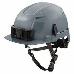 This MILWAUKEE climbing helmet is a Type 2, Class E model made of gray polyethylene with a ratchet suspension adjustment and a headlamp mount. It provides protection against lateral impacts and electrical hazards up to 20,000 V. Suitable for work-at-height, construction, utilities, and confined-space applications.