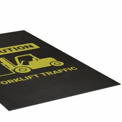 This 3 ft x 5 ft polypropylene entrance mat features a slip-resistant surface and adhesive backing for secure placement. The 1/8 in thick mat displays a caution message for forklift traffic, suitable for use at entry points in industrial and warehouse environments to alert personnel.