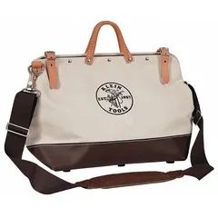 This brown canvas wide-mouth tool bag from KLEIN TOOLS measures 24 inches wide by 6 inches deep by 15 inches high. It features 17 inside pockets for organized storage of hand tools, meters, and small parts. The wide-mouth opening provides easy access to contents, making it suitable for tradespeople on job sites.