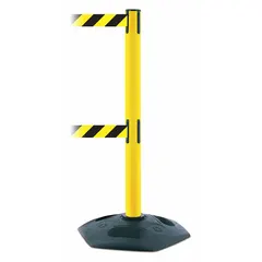 This retractable belt post barrier features a yellow plastic post with a rubber base and a 7 1/2 ft black/yellow belt printed with a chevron pattern and no legend. Used for crowd control, queue management, and safety delineation in industrial facilities, airports, and event spaces.