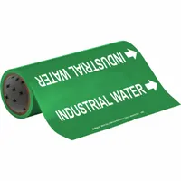 Green adhesive pipe marker with white legend text reading 'Industrial Water' and flow-direction arrows. Each roll contains 30 markers that fit pipe outer diameters from 2-1/2 to 6 inches. Used to identify industrial water lines in facility piping systems