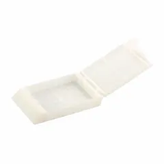 Embedding cassette made of white polyoxymethylene, measuring 1.65 inches in length and 1.12 inches in width. Used in histology and pathology laboratories for embedding tissue samples in paraffin wax, holding specimens during processing, sectioning, and storage.