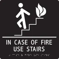 Adhesive sign with white/black background, nominal size 9 in x 9 in. Features Braille and visual text for emergency egress instructions. Designed for wall mounting in commercial buildings, hotels, and public facilities to indicate safe evacuation routes