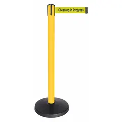 This retractable belt post barrier features a yellow ABS and metal alloy construction with a 10 ft black belt printed with 'Cleaning in Progress'. It is used to cordon off areas and communicate temporary hazards or restricted zones in commercial facilities, retail spaces, and public venues.