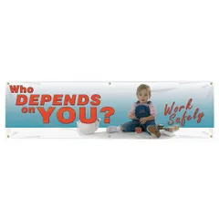 Indoor/outdoor banner printed on one side with the message 'Who Depends On You? Work Safely'. Made of poly sheeting, measuring 28 in x 96 in. Used to promote workplace safety awareness in industrial facilities such as manufacturing, warehousing, and construction environments.