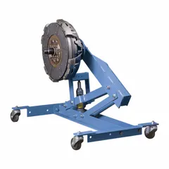 This hydraulic clutch and flywheel jack has a 0.1 ton load capacity and a steel frame. It is operated by a lever and features a spindle securing mechanism for precise positioning. Used in vehicle maintenance for lifting and aligning clutches and flywheels during transmission service.