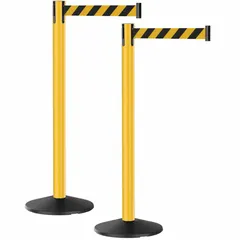 Two-post retractable belt barrier system with 40 in post height and 10 ft black/yellow patterned belt. Round sloped base with yellow finish. Used for pedestrian guidance, queue management, and area delineation in industrial and public spaces.