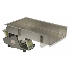 Vibratory feeder with a feed rate of 14,000 lb/hr, 24 in trough length, 10 in trough width, and 6 7/8 in discharge height. Used for controlled metering and conveying of bulk materials in industrial processing lines.