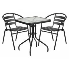 This square patio table set includes a 23 1/2 in wide glass-topped table and two metal chairs with powder-coated black frames. The chairs feature metal seat and back, and plastic floor glides. Suitable for outdoor dining or seating on decks, patios, or balconies.