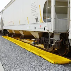 This railroad track berm is a secondary containment solution for capturing leaks and drips under outrigger pads on rail tracks. Constructed from PVC, it measures 60 ft x 30 in x 4 in and has a spill capacity of 374 gallons.