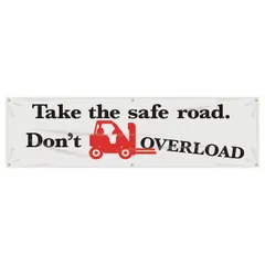 Indoor/outdoor banner printed on one side with the message 'Take The Safe Road. Don't Overload Banners.' Made of poly sheeting, measuring 28 in x 96 in. Suitable for use in warehouses, loading docks, and manufacturing areas to promote safe load limits.